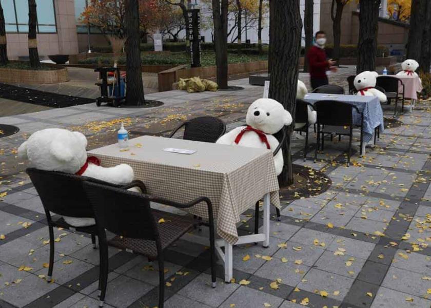 Las mesas y sillas se colocan con desinfectantes de manos y juguetes de peluche mientras se mantiene el distanciamiento social en el centro de Seúl, Corea del Sur. Foto: AP