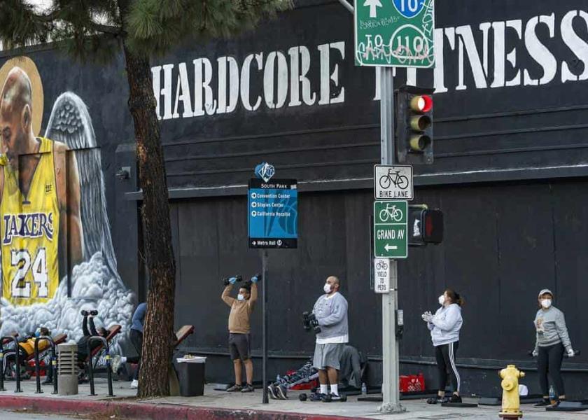 Varias personas portan mascarillas para protegerse del coronavirus mientras se ejercitan afuera del gimnasio Hardcore Fitness, en Los Ángeles. (AP FotoDamian Dovarganes, archivo)