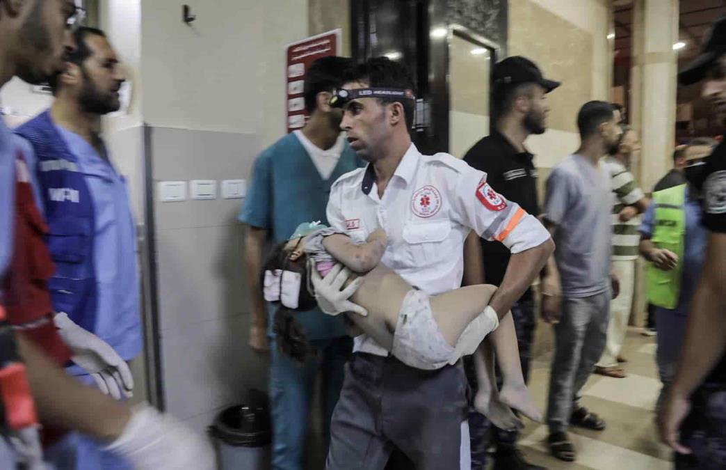 Un paramédico sostiene a un niño herido en uno de los hospitales de la Franja de Gaza / Foto: EFE
